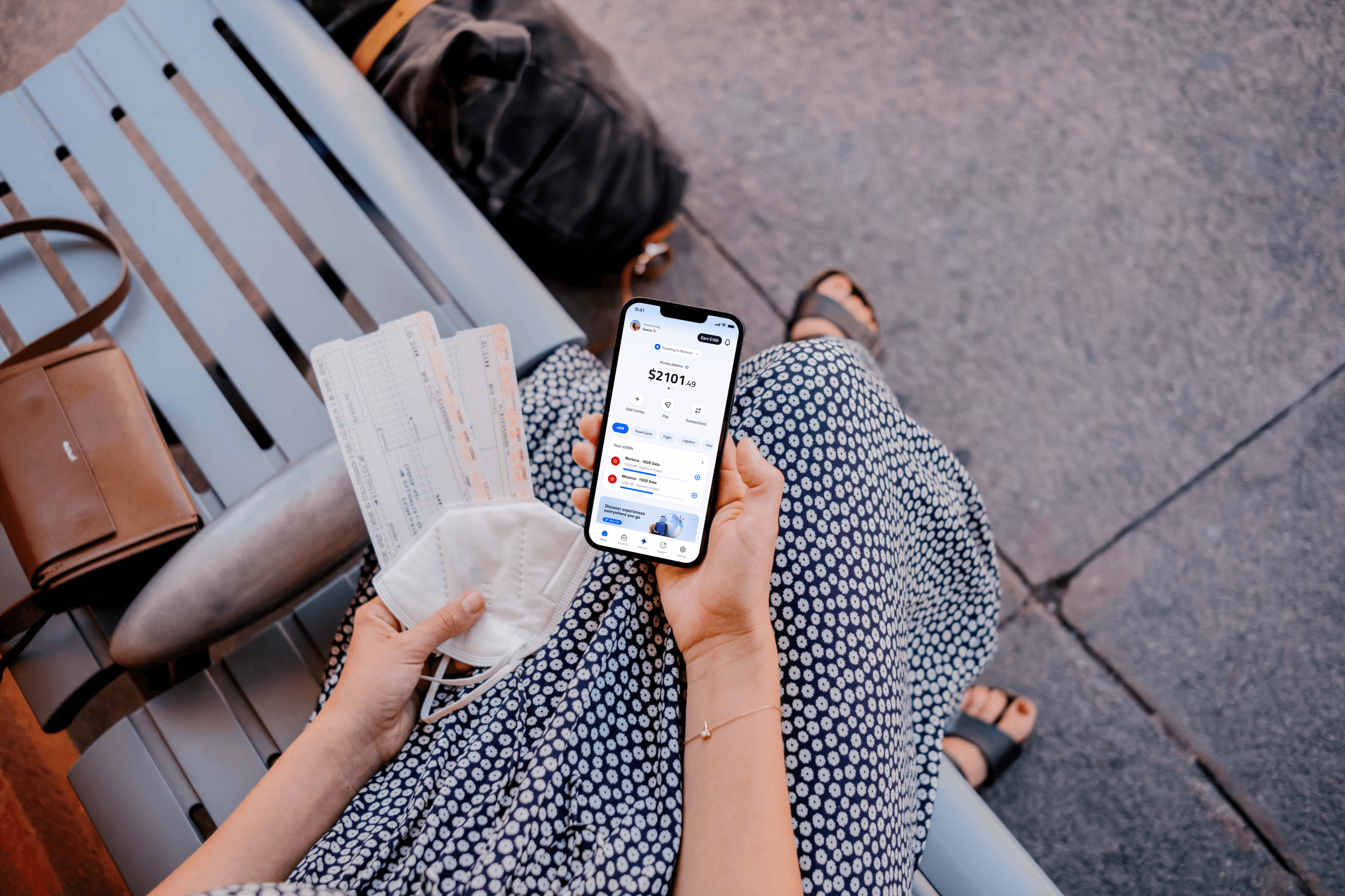Traveler holding phone with Getly eSIM while checking boarding tickets